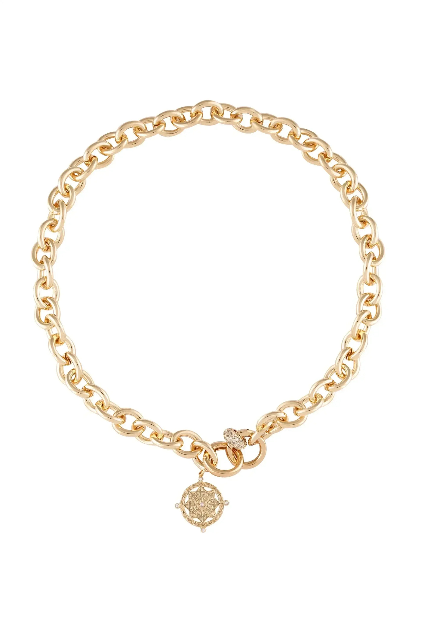 A gold chain necklace features interlocking links and a decorative pendant with a detailed design. The piece is presented against a plain white background, highlighting its elegance and shine.