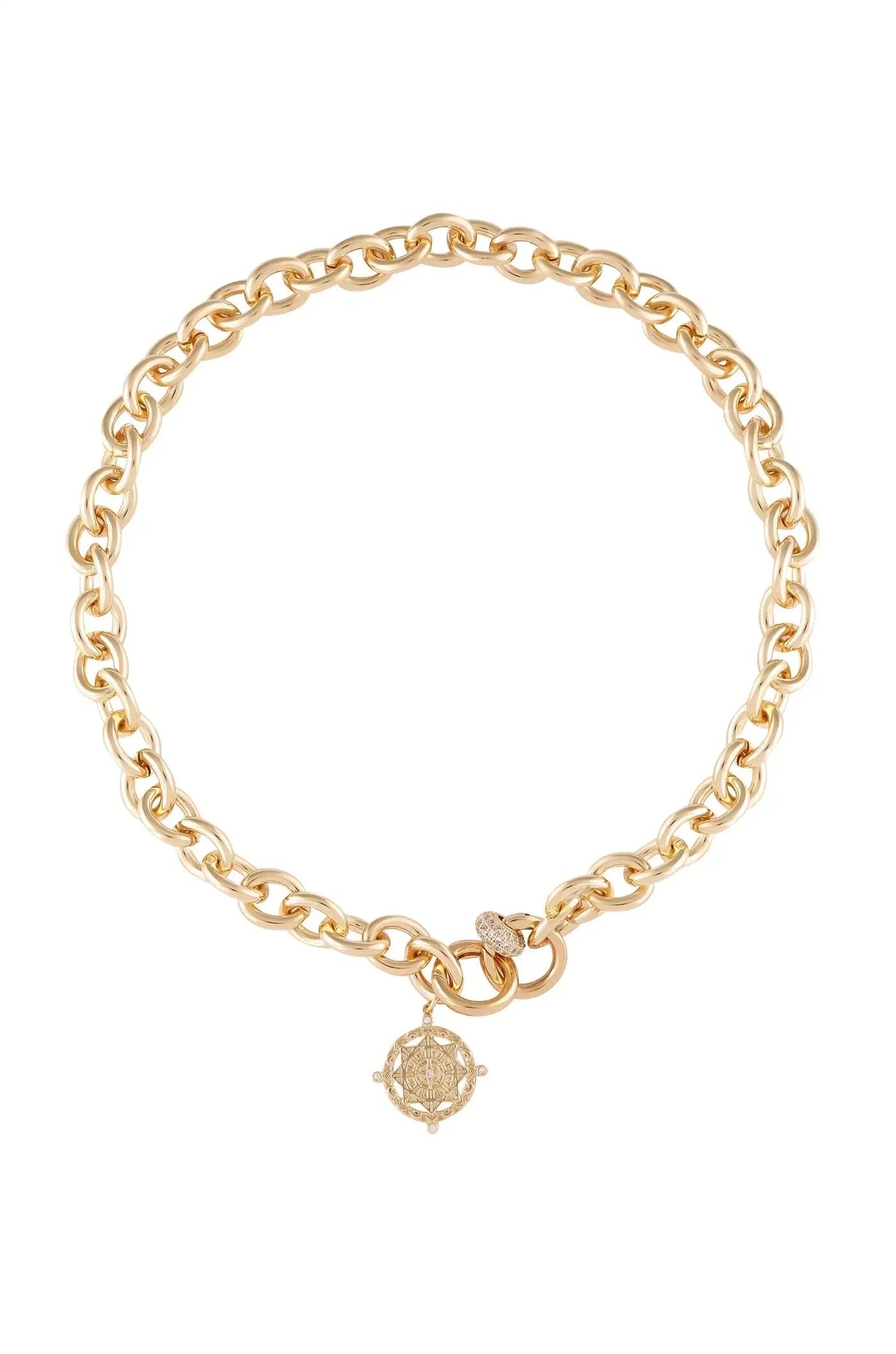 A gold chain necklace features interlocking links and a decorative pendant with a detailed design. The piece is presented against a plain white background, highlighting its elegance and shine.