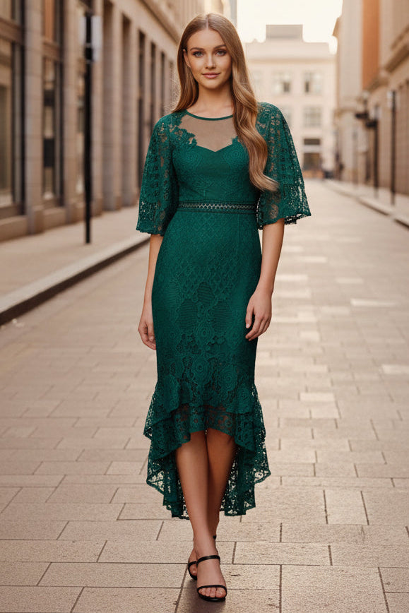 Woman wearing a green lace dress on a city street