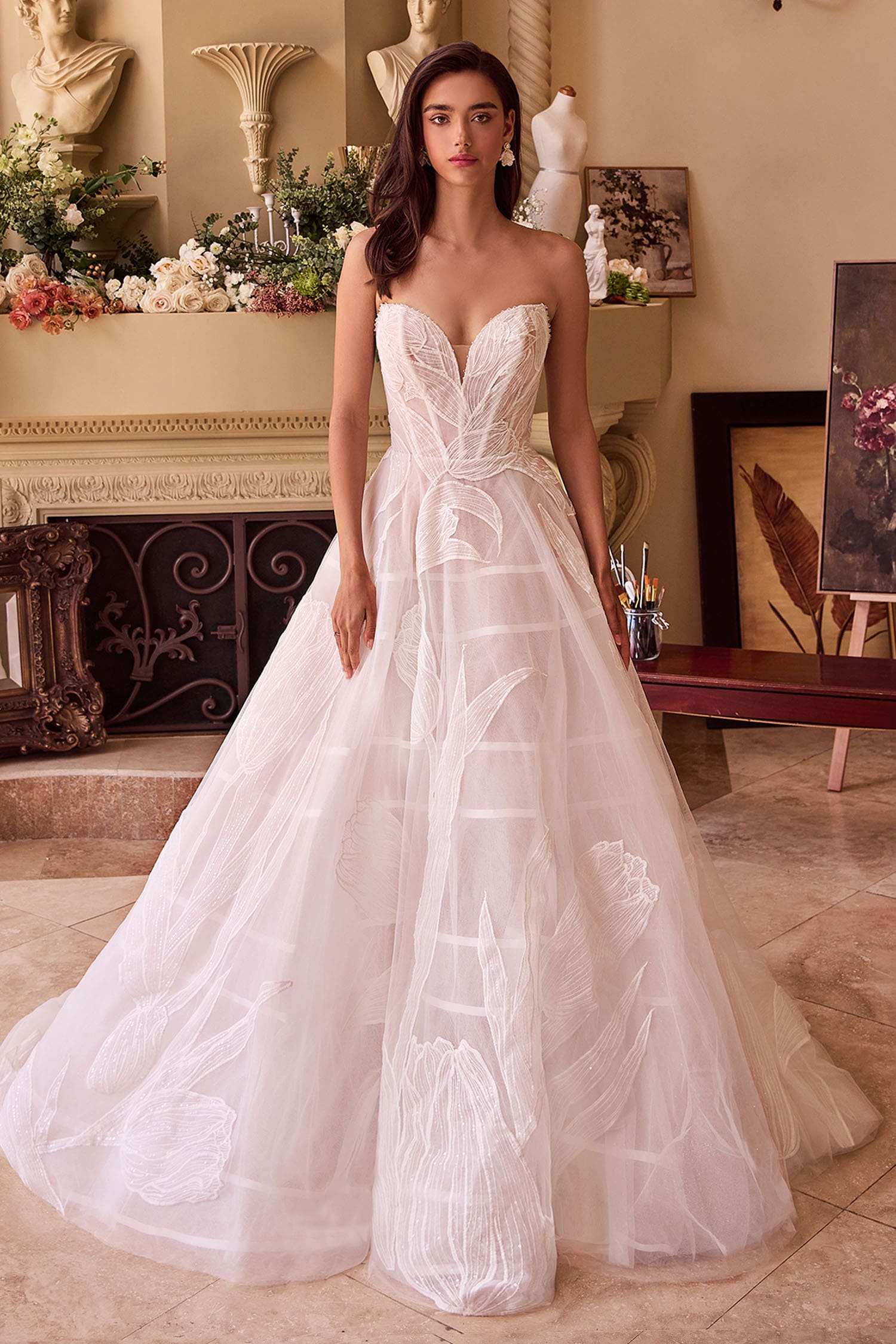 Woman wearing a strapless white wedding dress in an elegant indoor setting.