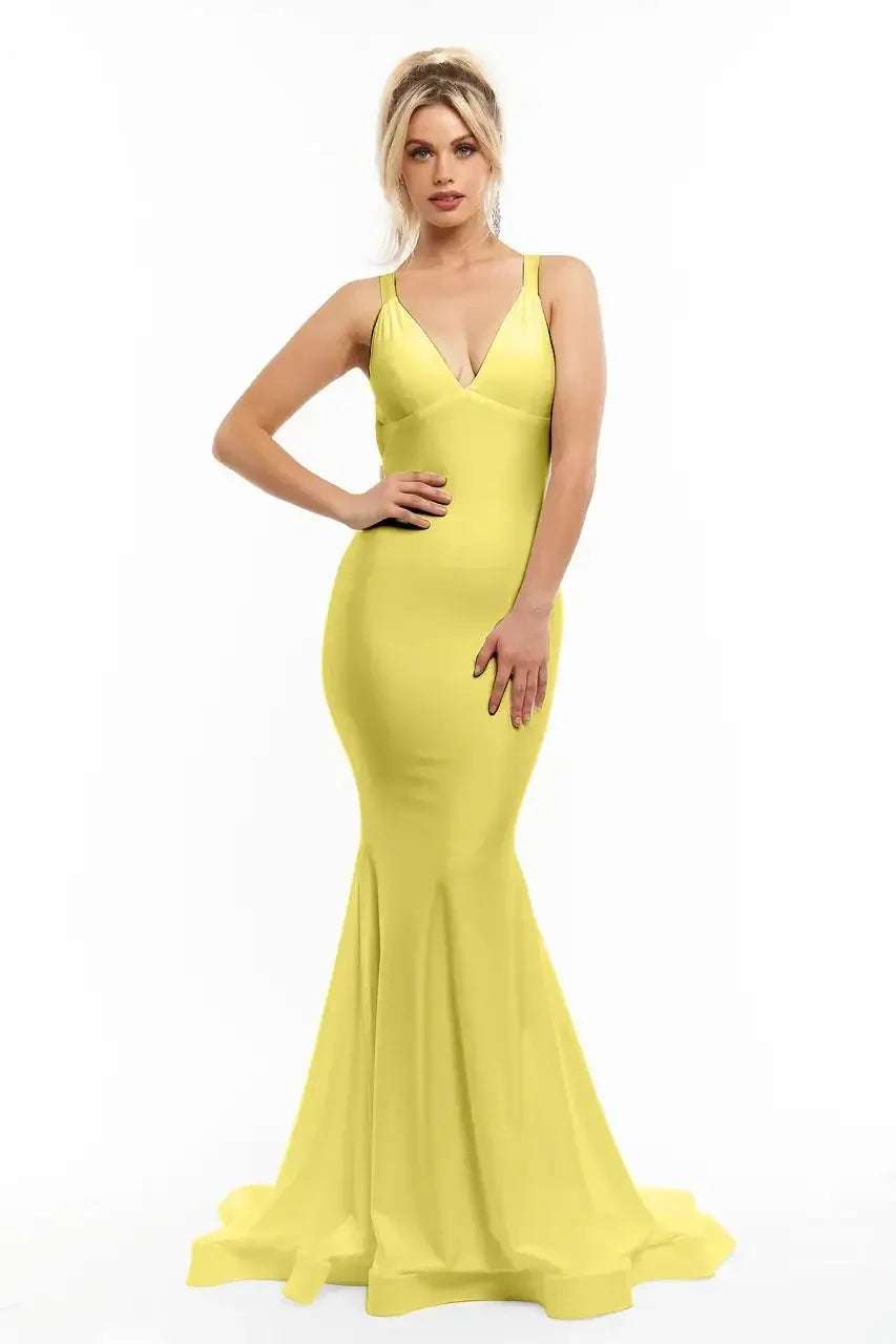 A woman poses confidently in a fitted, vibrant yellow dress with a flared hem. Her long hair and subtle accessories complement the dress against a plain white background.