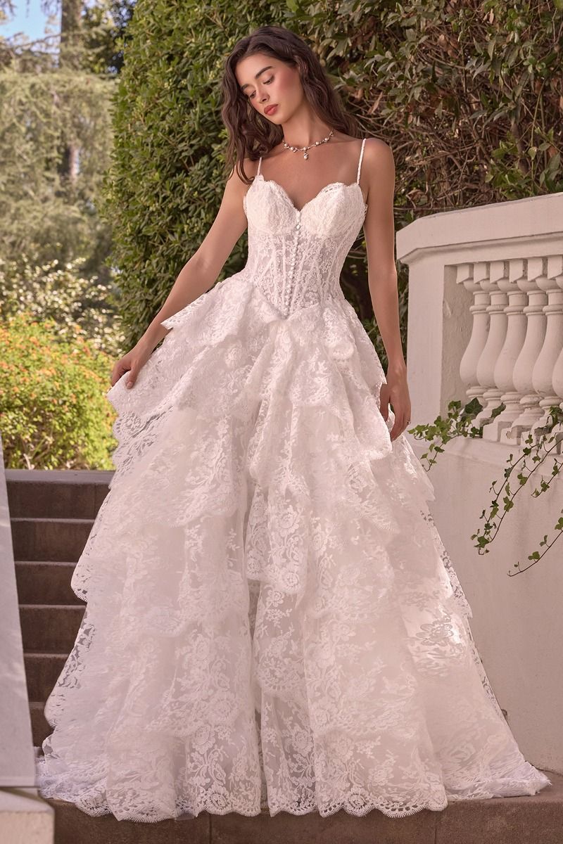 WL076 - LAYERED SCALLOP LACE A-LINE GOWN - Andrea & Leo | Lady Black Tie | A woman wearing a white lace wedding gown with thin straps, a fitted corset-style bodice, and a full layered skirt.